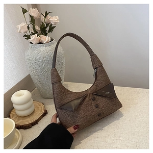Détail d'un sac en tissu marron avec un col de chemise créatif et trois boutons décoratifs