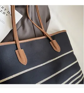 Macro detail of high-quality striped canvas texture and leather handle on a tote bag