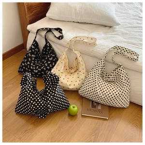 Detail of canvas tote bags in four patterns including polka dots and bows for daily use