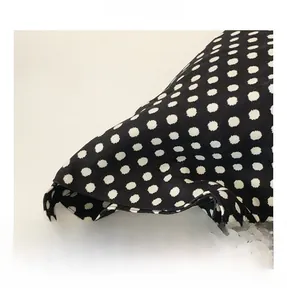 Detail showing high-quality black fabric with white polka dots and fine stitching