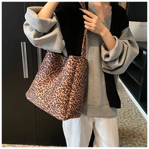 Leopard print tote bag shown on model highlighting its spacious capacity and wide strap