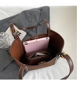 Top view of spacious brown tote interior with compartments for tablet and phone