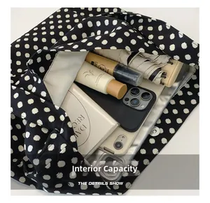 Detailed view of the large capacity interior of a polka dot tote bag with magnetic closure