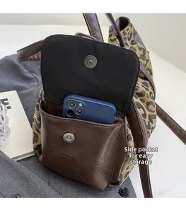 Leopard print tote side pocket detail with brown leather trim and magnetic closure