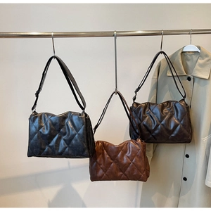 Detailed view of quilted rhombic pattern shoulder bags in black, coffee, and brown leather