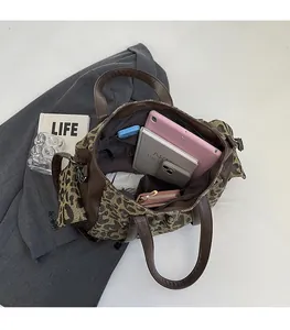 Macro view of leopard print tote bag interior with large capacity and zipper pocket