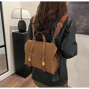 Detail of vintage caramel brown frosted leather backpack with classic metal buckles