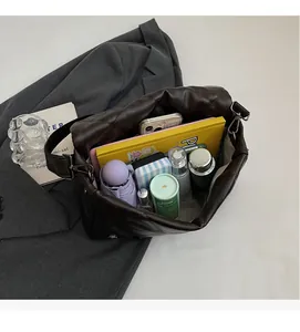 Spacious interior of a dark brown quilted tote bag showing large storage capacity
