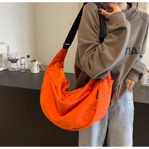 Bright orange crescent nylon crossbody bag with adjustable black shoulder strap