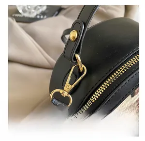 Close-up of golden swivel hook and zipper details on vintage leopard print handbag