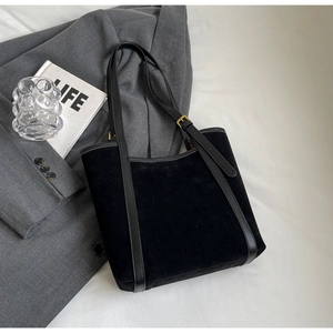 Minimalist black PU leather tote bag with suede texture and adjustable gold buckle straps