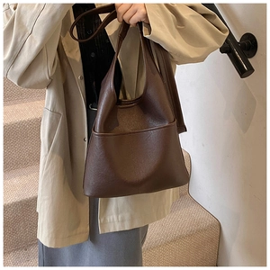 Detail view of deep brown vintage leather tote with vertical stitching and large capacity