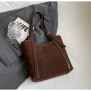 Stylish dark brown suede tote bag with leather trim and adjustable straps for women
