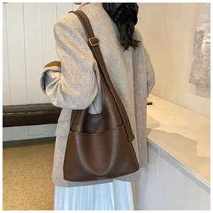 Detailed view of dark brown leather hobo bag with adjustable wide shoulder strap