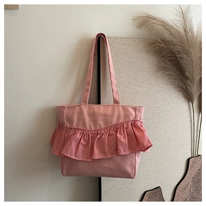 Close-up of pink canvas tote bag with elegant ruffled folds and soft fabric texture