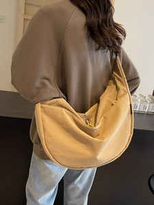 Minimalist crescent moon crossbody bag in khaki nylon fabric for daily commute