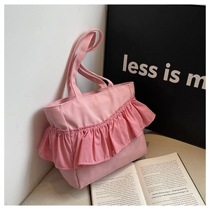 Close-up of pink canvas tote bag showing artistic ruffle pleat details and fabric texture