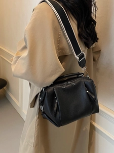 Black pebbled leather pillow bag with stylish wide striped crossbody strap for women
