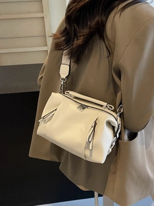 Chic off-white pleated pillow bag with wide strap and silver hardware for women