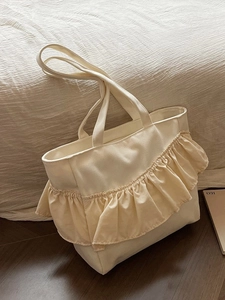 Chic beige canvas tote bag with pleated ruffle accents and large capacity design