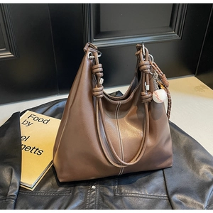 Brown vintage tote bag featuring woven rope handles and contrast stitching details
