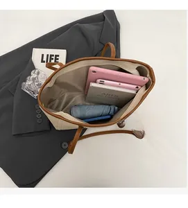 Top view of spacious tote bag interior showing capacity for tablet and notebook