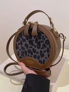 Retro round crossbody bag with leopard print fabric and brown leather handheld strap