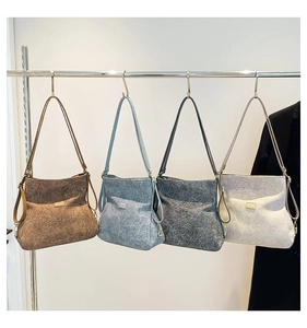 Detailed row of textured faux leather handbags in brown, blue, grey, and cream colors