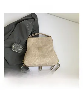 Macro shot of beige wrinkled texture leather with elegant metallic logo nameplate