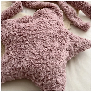 Detail view of the soft faux fur texture on a pink star-shaped plush shoulder bag