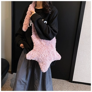 Detailed look at the large star-shaped plush crossbody bag in soft pink faux fur material