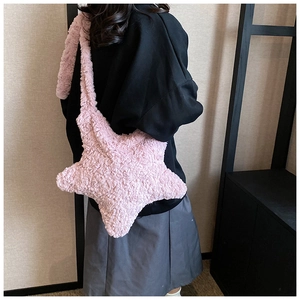 Detail of soft pink plush star-shaped shoulder bag with fuzzy lamb wool texture