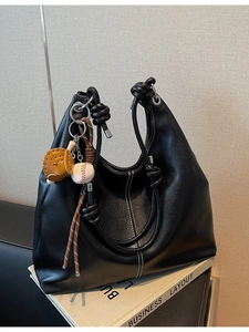 Retro black faux leather tote bag with white contrast stitching and baseball charm