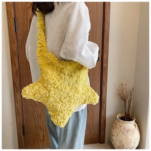 Star-shaped plush shoulder bag in yellow shown from a back view on a female model