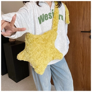 Detailed texture of star shaped plush bag with yellow curly faux fur finish and strap