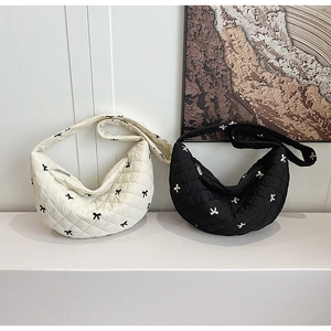 Quilted crescent bags with micro bow embroidery in cream and black colorways