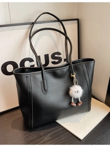 Classic black faux leather tote bag with a cute white plush monster charm for women