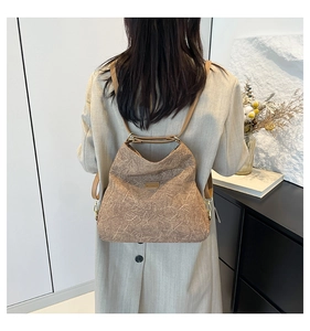Detailed back view of a brown backpack with wrinkled marble texture and slender straps
