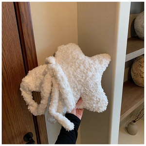 Detailed plush texture of the star-shaped crossbody bag in soft pearl white faux fur