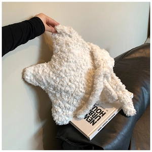 Detailed close-up of a white star-shaped plush shoulder bag with soft fuzzy texture