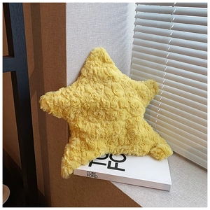 Detail of star-shaped plush bag featuring yellow faux fur with 3D rose swirl texture