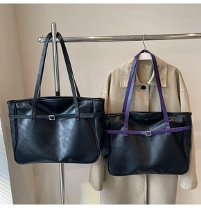 Detailed display of large capacity tote bags with metal buckles and leather texture