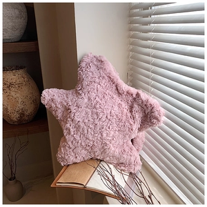 Detail of pink star plush bag showing soft faux fur texture in natural window light