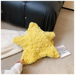 Close-up of yellow star-shaped plush bag showing fluffy faux lamb wool texture details