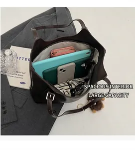 Deep brown tote bag showing spacious interior with tablet, phone and umbrella