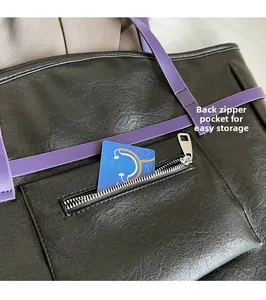 Close-up of black PU leather tote bag with back zipper pocket and purple strap detail
