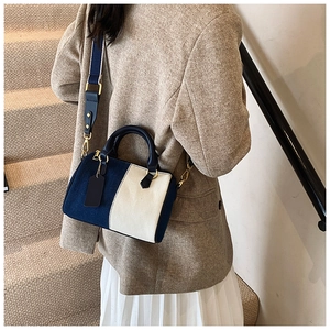 Dettaglio della borsa Boston con contrasto in tela blu navy e crema e finiture dorate