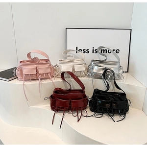 Detailed display of pleated baguette bags in pink beige silver burgundy and black