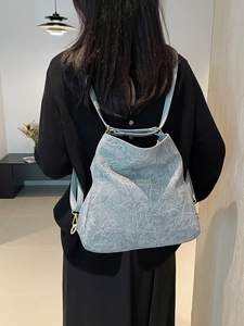 Minimalist textured light blue backpack for women with unique artistic crinkle pattern