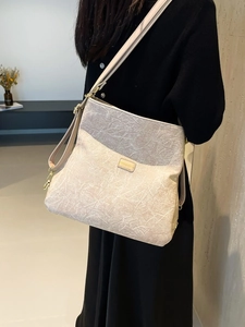 Chic beige textured faux leather crossbody bag with adjustable strap and gold hardware